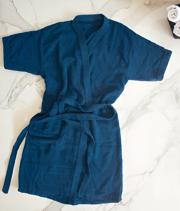 A blue bathrobe on white background.